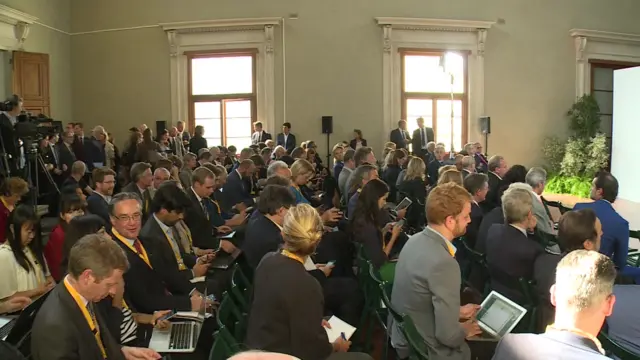 The venue in Florence fills up ahead of the PM's speech