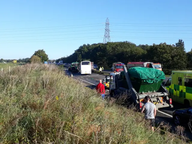 People standing beside stationary cars