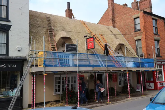 The pub is covered in scaffolding as the new thatch is laid