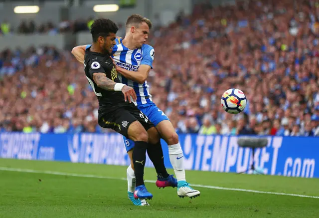 Solly March of Brighton and Hove Albion tussles with DeAndre Yedlin of Newcastle United