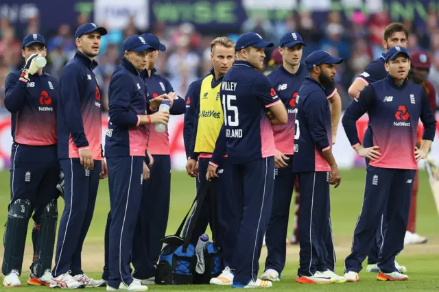 The England team look towards the big screen as they successfully review a decision