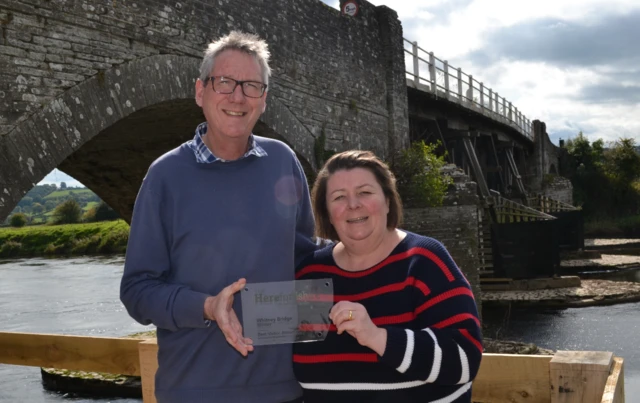 Grahame Penny and Maggie Taylor in front of their bridge