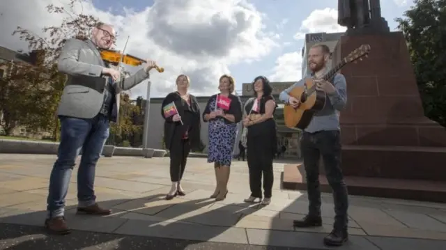 Culture Secretary Fiona Hyslop with Paisley 2021 bid director Jean Cameron, Renfrewshire's Provost Lorraine Cameron, and musicians Ron Jappy and Sean Grey