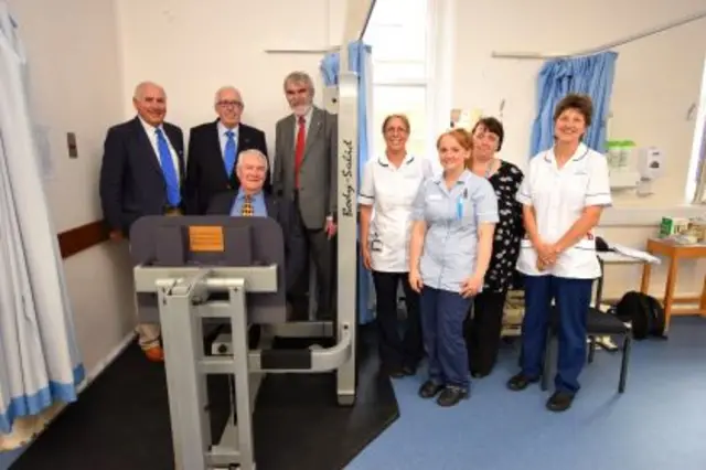 Fundraisers and hospital staff with new leg press