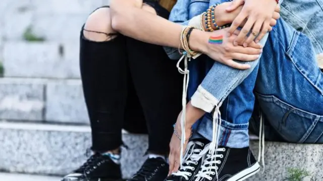 Two women sitting on step