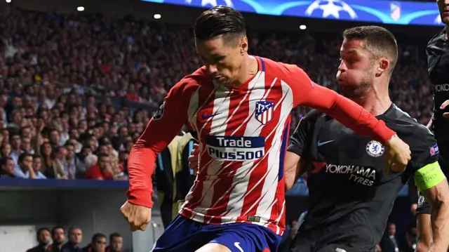 Fernando Torres of Atletico Madrid is tackled