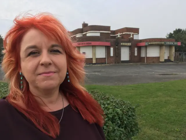 Caroline Jones outside the boarded-up pub