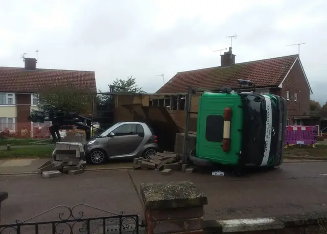 Overturned lorry on parked car