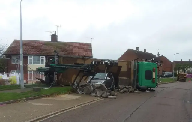 Overturned lorry on parked car