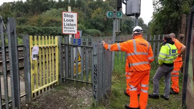 Police and rail staff at the Wallows Lane foot crossing on Wednesday