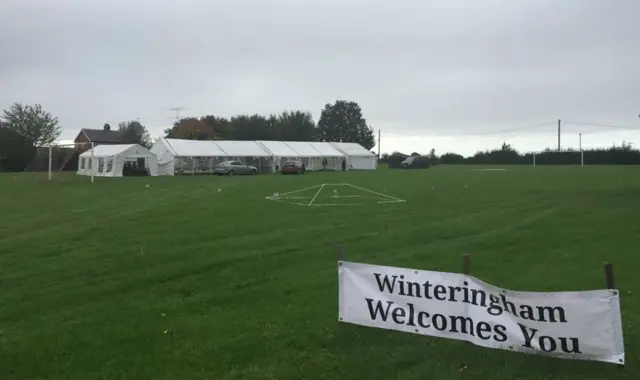 Field with marquees getting ready for festival.