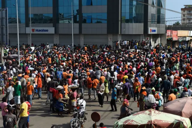 Protesters gather in a road during a rally held by a coalition of opposition parties in Lome on September 21, 2017