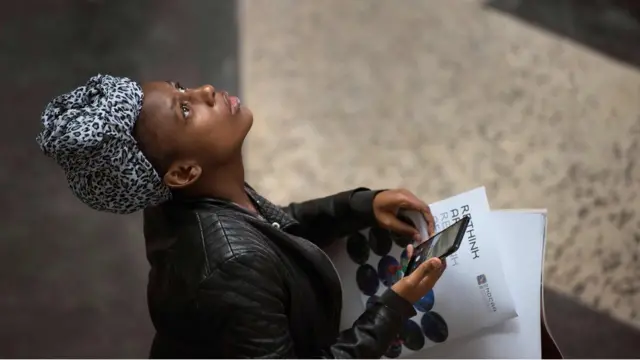 A woman looks at an exhibit in the main hall of the Zeitz Museum of Contemporary African Art in Cape Town on September 22, 2017.