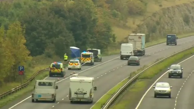 Police at the scene by the side of the A15.