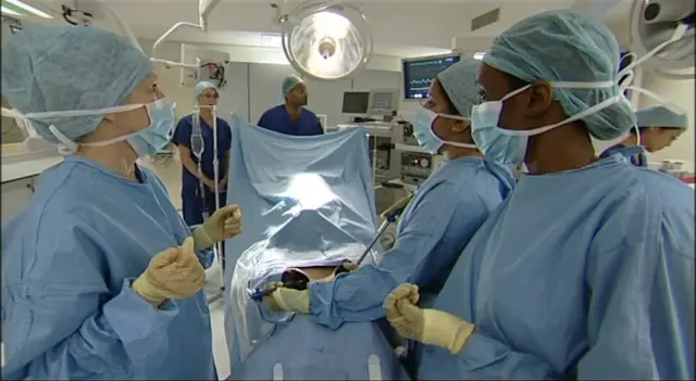 Surgeons and hospital staff inside an operating theatre