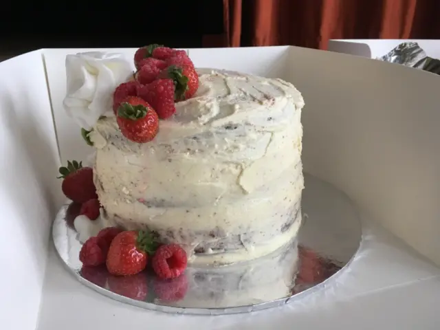 A red velvet cake, with fresh fruit