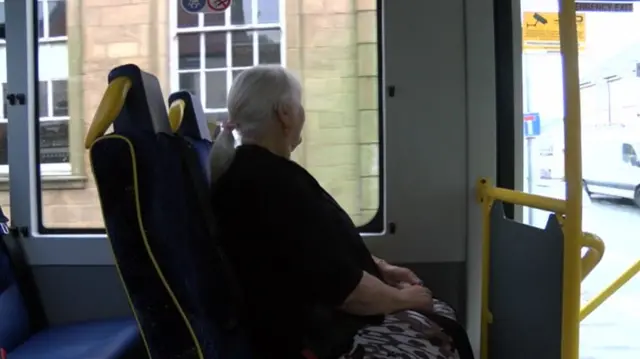 Woman sat on minibus.