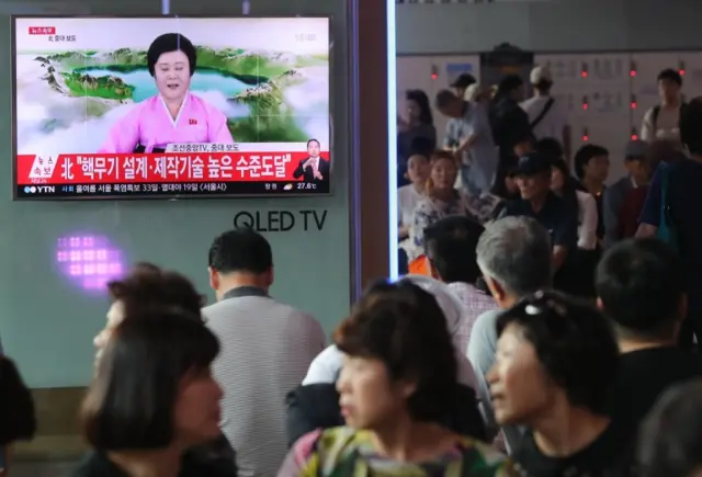 People in Seoul watch news reports