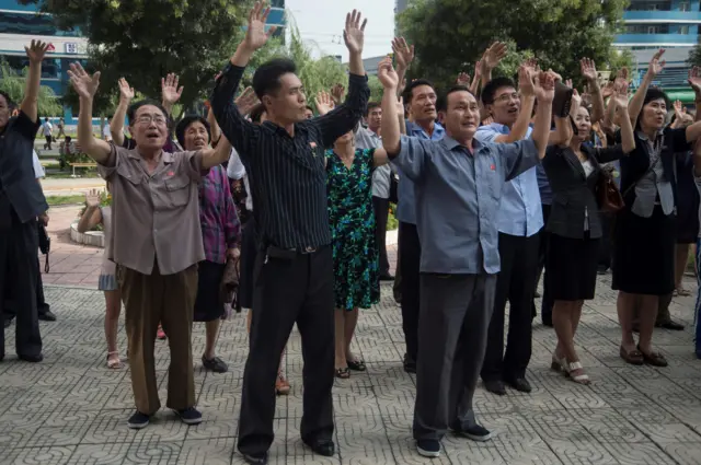 People waving their arms in celebration