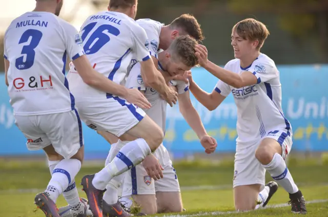 Coleraine players rush in to congratulate Jamie McGonigle after he makes it 2-0 against Ballymena