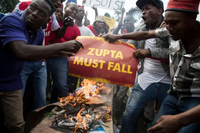 People burning placard