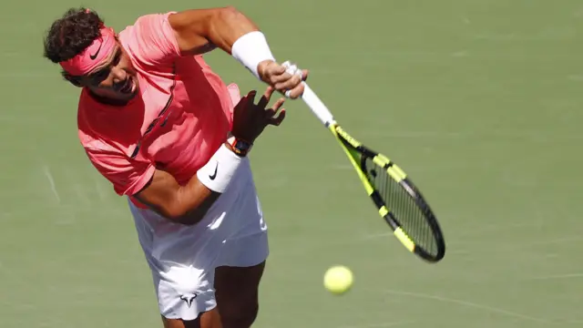 Rafael Nadal serves