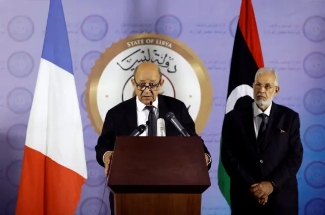 French Foreign Affairs Minister Jean-Yves Le Drian (L) speaks during a news conference at the headquarters of the prime minister"s office in Tripoli