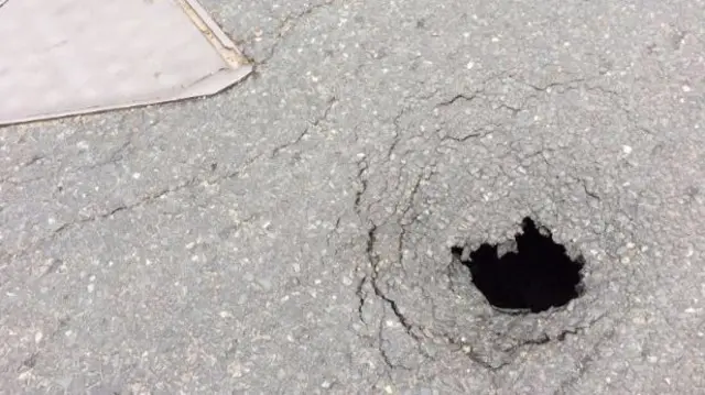 Hole in road