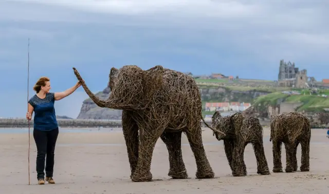 Emma Stothard with her elephant family on the beach at Whitby