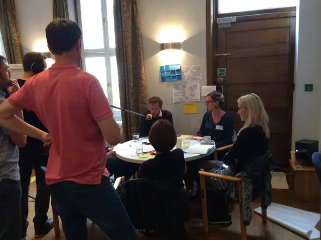 Matthew Taylor stands before table of Fix participants