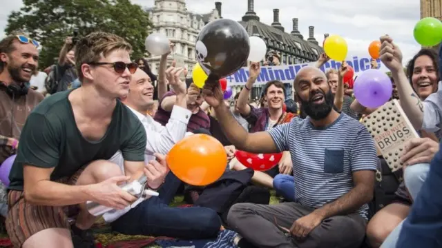 Protesters stage a mass inhalation of Nitrous Oxide