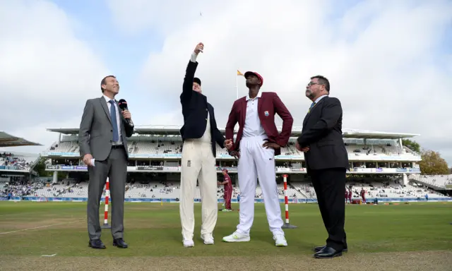 England captain Joe Root tosses the coin alongside West Indies captain Jason Holder