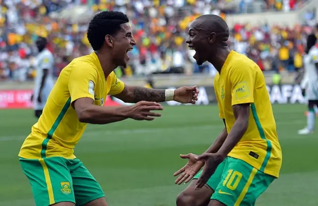 South Africa's Thulani Serero (R) celebrates with South Africa's Keegan Dolly (L) after scoring a goal during the 2018 World Cup qualifying football match between South Africa and Senegal on November 12, 2016 at the Peter Mokaba stadium in Polokwane