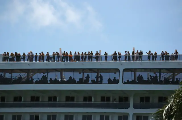 People stand on the top deck of a departing cruise ship as the Miami prepares for the approaching Hurricane Irma, 7 September 2017. Current tracks for Hurricane Irma shows that it could hit south Florida this weekend.