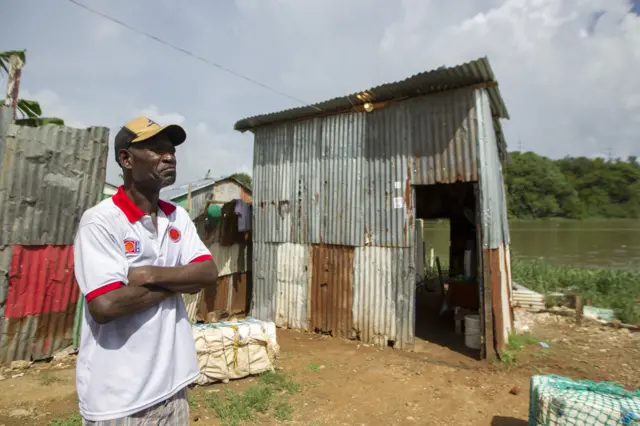 Image shows a man standing outside his house before the arrival of Hurricane Irma in the Dominican Republic on September 6