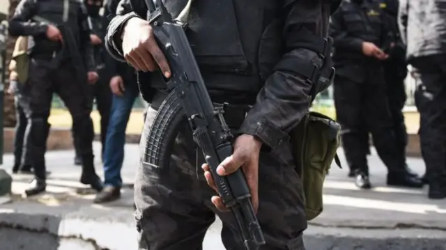 A soldier holding a kalashnikov gun