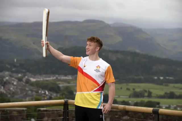 Athlete Lewis Johnstone with the Commonwealth Games baton at Stirling Castle
