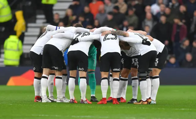 Derby players huddle