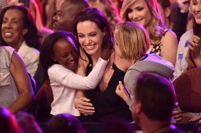 Actress Angelina Jolie hugs Zahara Marley Jolie-Pitt (L) and Shiloh Nouvel Jolie-Pitt (R) after winning award for Favorite Villain in 'Maleficent' during Nickelodeon's 28th Annual Kids' Choice Awards held at The Forum on March 28, 2015 in Inglewood, California.