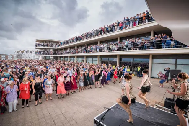 People line up to dance the Charleston in front of the De La Warr