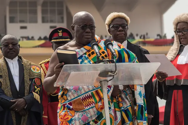 The winner of Ghana's presidential election Nana Akufo-Addo (C) takes the oath of office during the swearing-in as elected President of the fourth Republic of Ghana, in Independence Square in the capital Accra, on January 7, 2017.