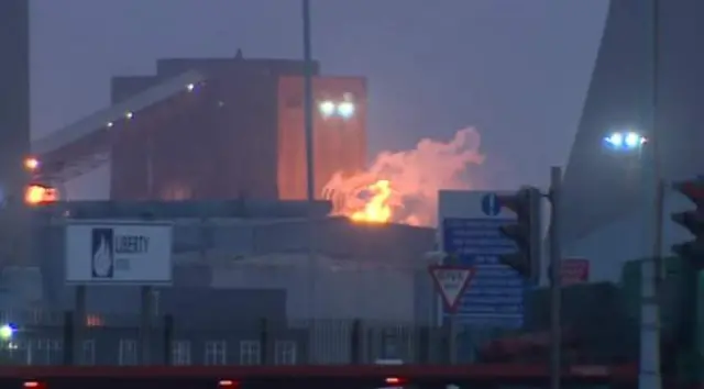 Scunthorpe steelworks with flames coming out of the top of one area.