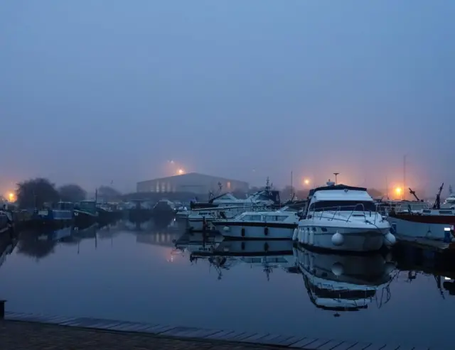 Boats in the water at Goole, surrounded by mist.