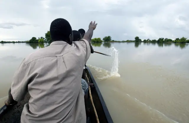 Men in a boat crossing a river