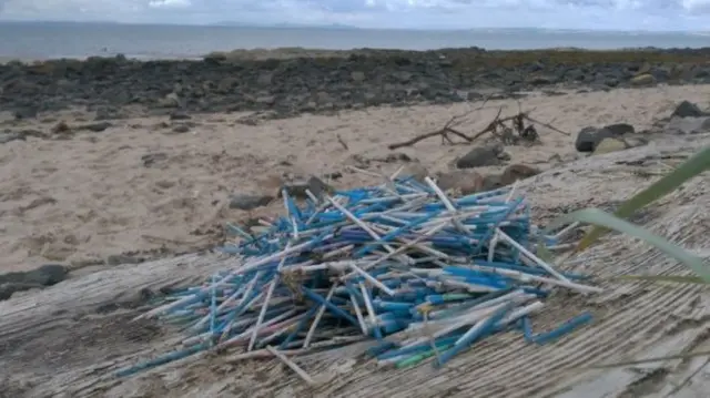 Cotton bud plastic left on beach