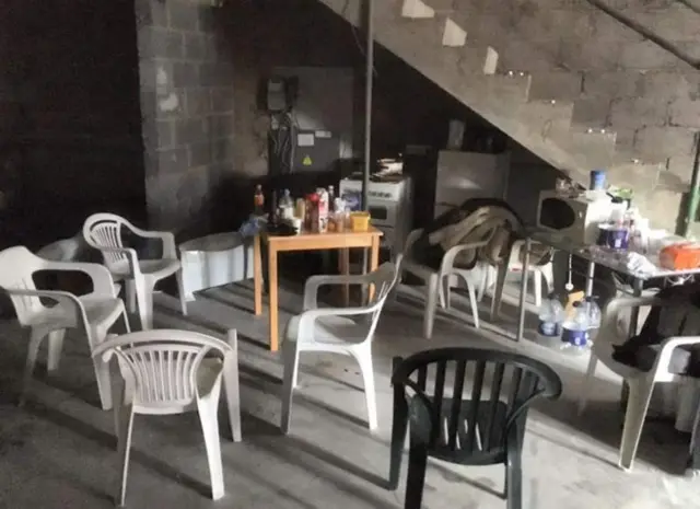 Chairs and tables in the semi-derelict building.