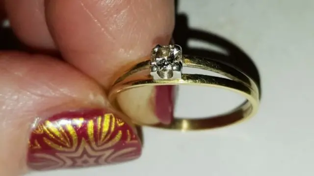 The diamond ring with a single diamond in the center.