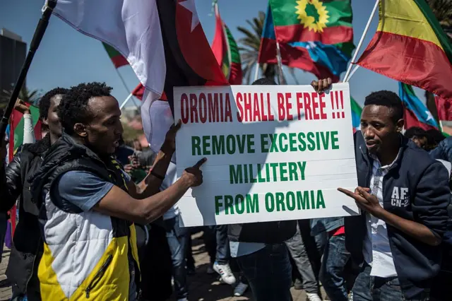 Demonstrators hold up a placard reading 'Oromia shall be free - remove excessive military from Oromia' as members of the Oromo, Ogaden and Amhara community in South Africa demonstrate against the ongoing crackdown in the restive Oromo and Amhara region of Ethiopia on August 18, 2016 in Johannesburg.