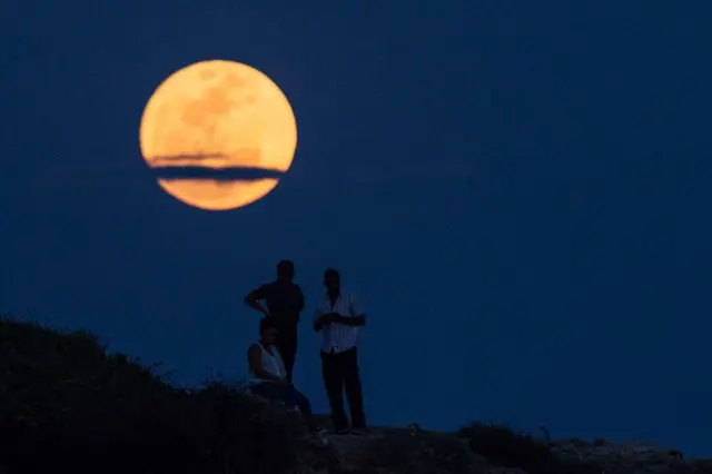 People watch the supermoon rising in Dar es Salaam on November 14, 2016