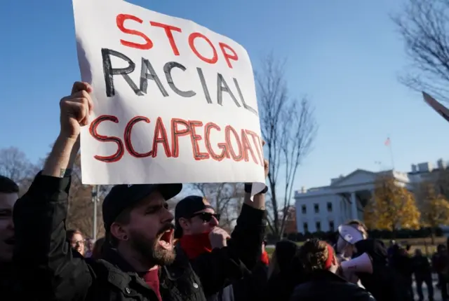 This file photo taken on December 3, 2017 shows counter-protesters shouting slogans at white nationalists during an anti-immigration rally front of the White House on Pennsylvania Avenue in Washington, DC.